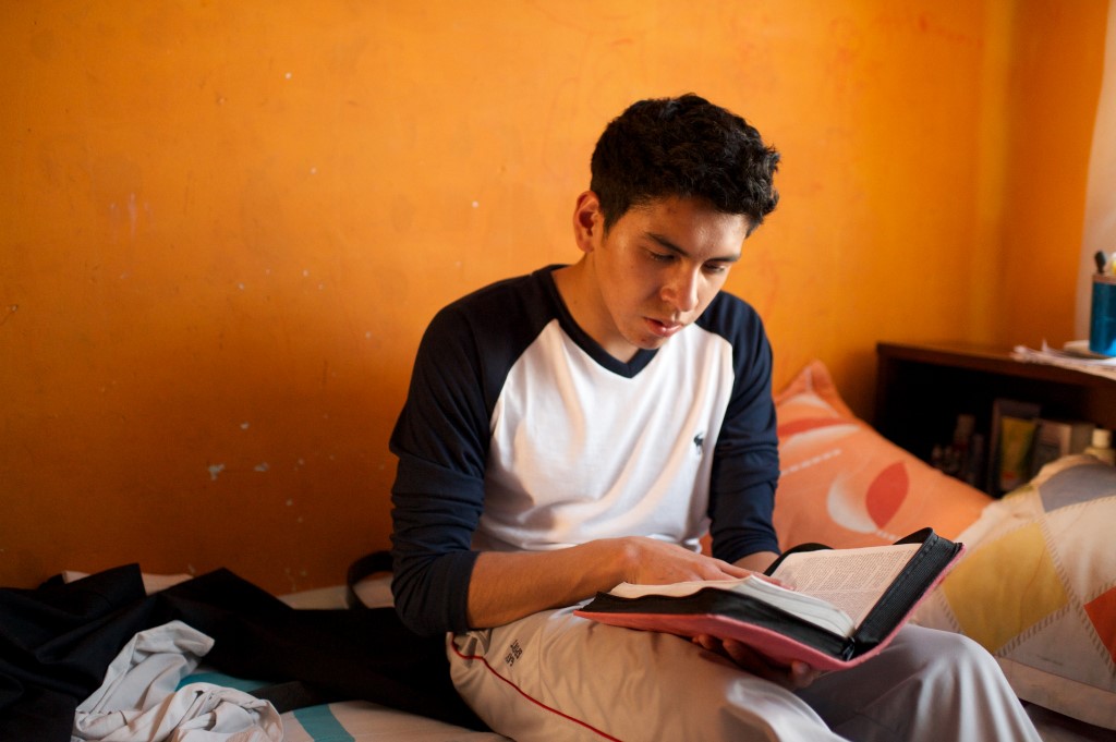 Boy reading scriptures.