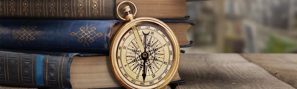 compass next to old books.