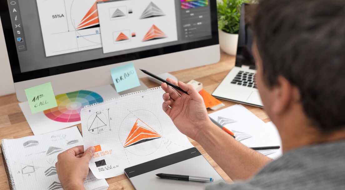 Graphic designer drawing sketches logo design. The concept of a new brand. Professional creative occupation with idea.
