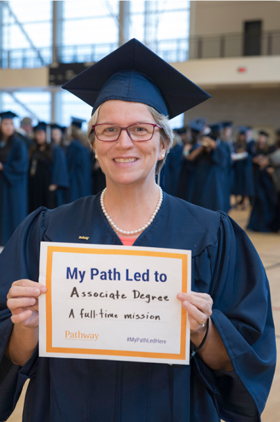 woman at graduation holding certificate