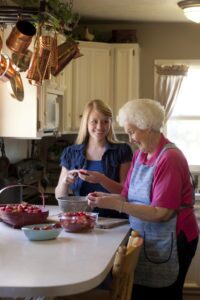 Young and Elderly Woman Making Strawberry Jam