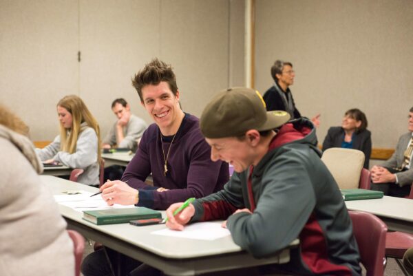 student writing on a paper