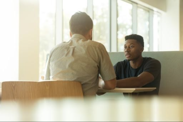 two men giving each other feedback