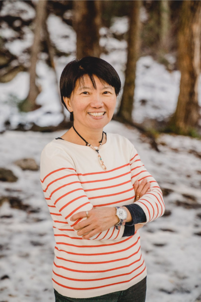 Wei-Tzu Lee smiles as she stands outside, a snowy landscape behind her