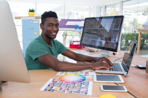 Man at computer with large monitor