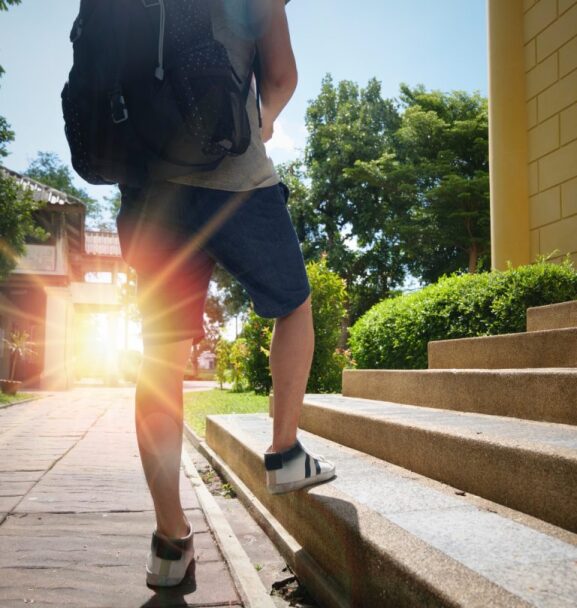 student walking up campus stairs