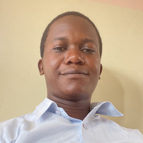 Ekirita Ivan Samuel smiling after earning his degree in applied business management.