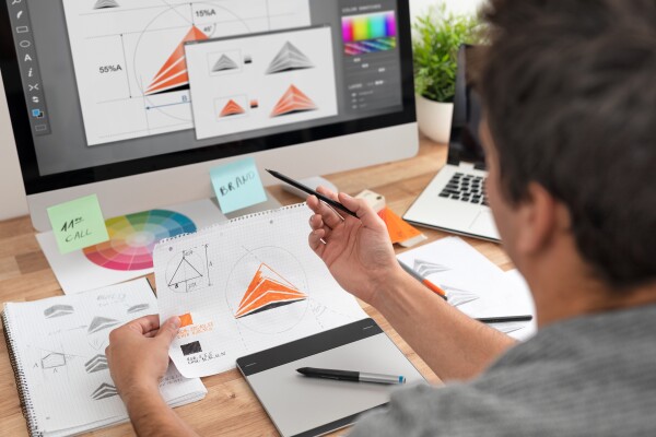 Graphic designer drawing sketches logo design.